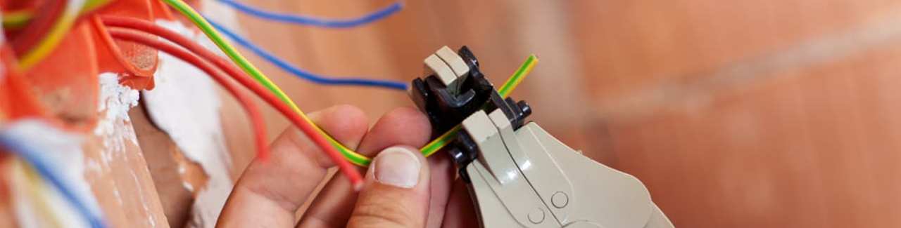 an electrician working on residential wiring to prevent a short circuit from occurring