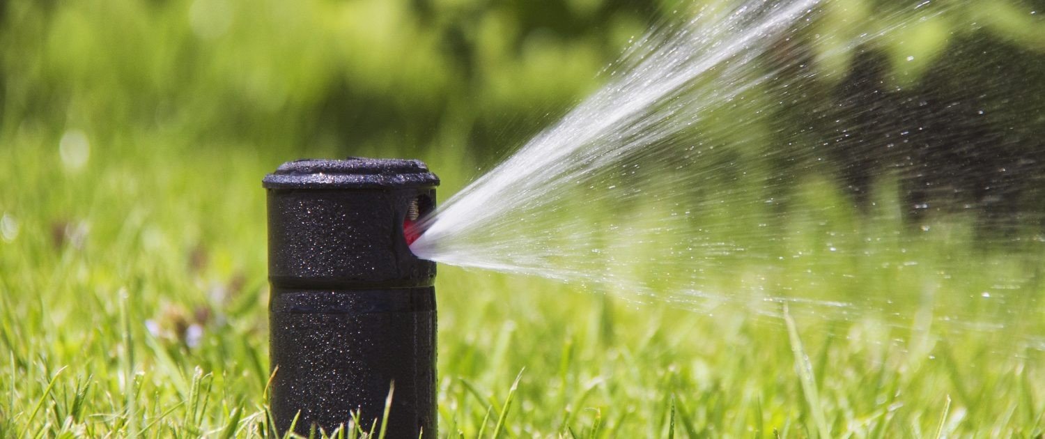 company installing sprinkler systems in a client backyard